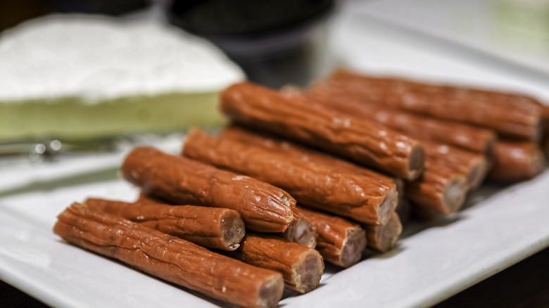 meat sticks stacked on a serving plate