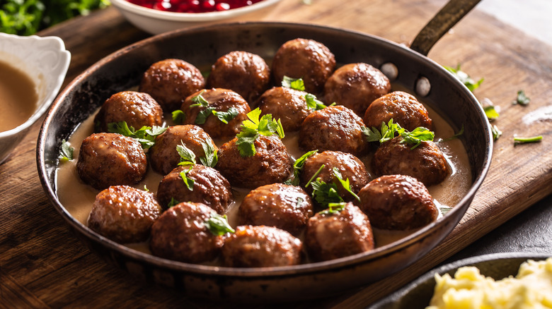 meatballs in pan with herbs