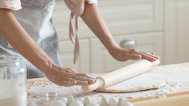 Home baker rolling out dough