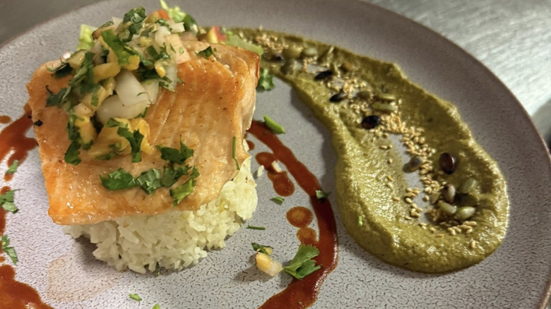 Plated salmon on rice with guacamole sauce at Casa Chimayó