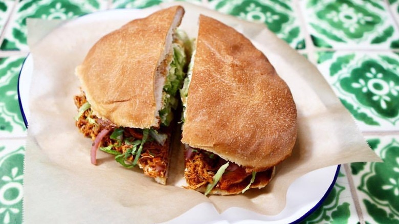 Plated pollo pibil cut in half at Güero