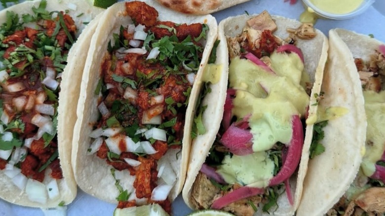 Four plated tacos at Tacos Chiwas