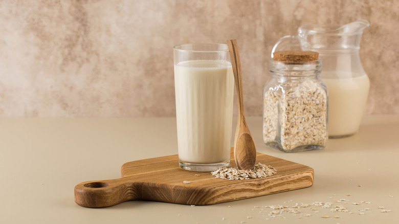 glass of oat milk on a wood board