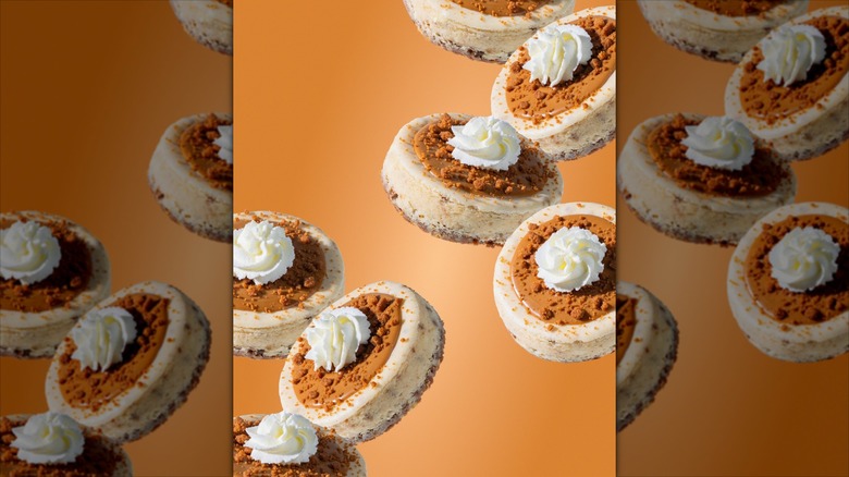 Crumbl Biscoff Cheesecakes on an orange background