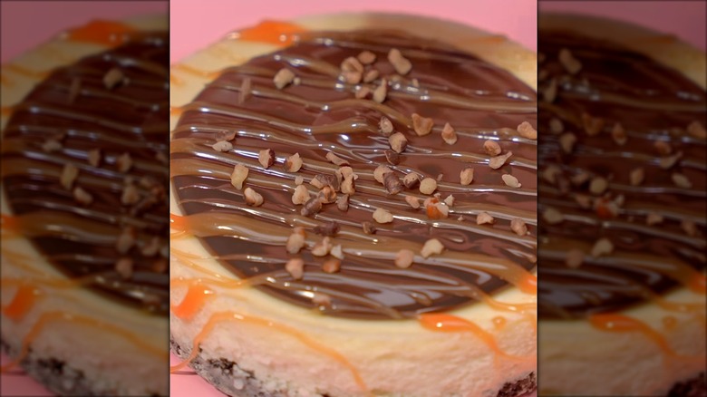 Close-up of Crumbl Turtle Cheesecake on a pink background
