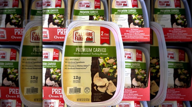 Package of Hillshire Farm oven roasted turkey breast with packages stocked in background