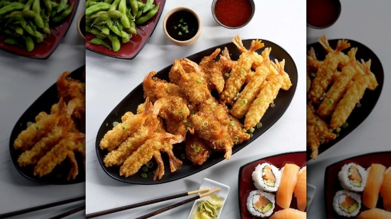 A plate of Sam's Club tempura and coconut shrimp served with edamame and sushi