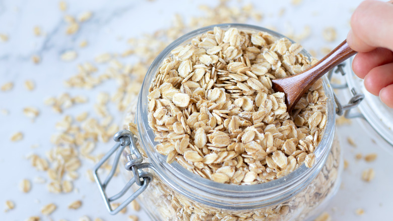 Jar and spoon of rolled oats