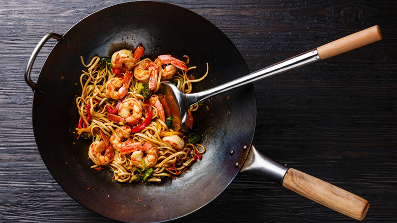 Top-down view of shrimp stir-fry in a wok