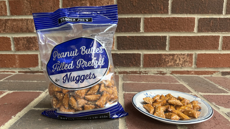 Bag of Trader Joe's Peanut Butter Filled Pretzel Nuggets next to plate of pretzels
