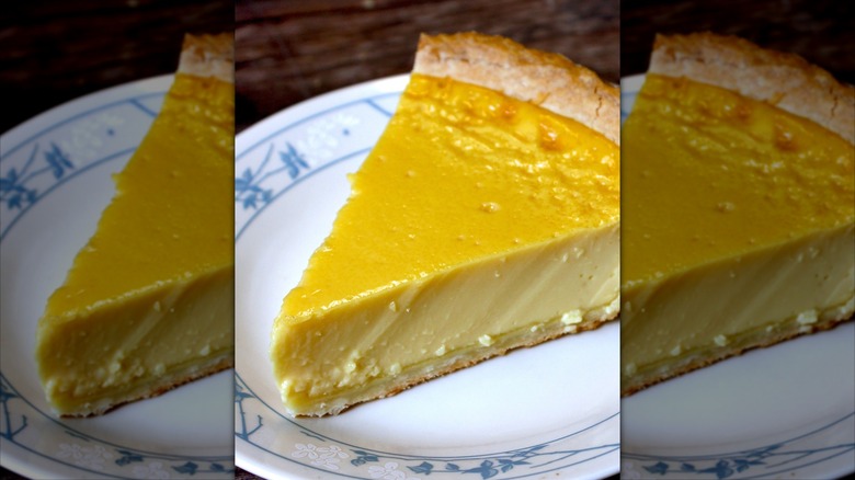 Slice of custard pie on white plate