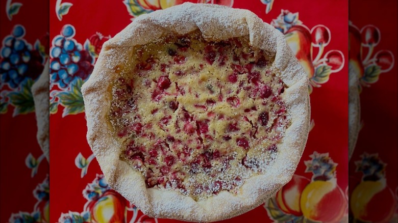 Closeup of cranberry custard pie on red tablecloth
