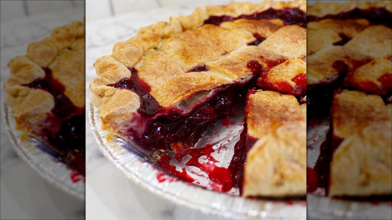 Close-up of cherry pie missing a slice in pie pan