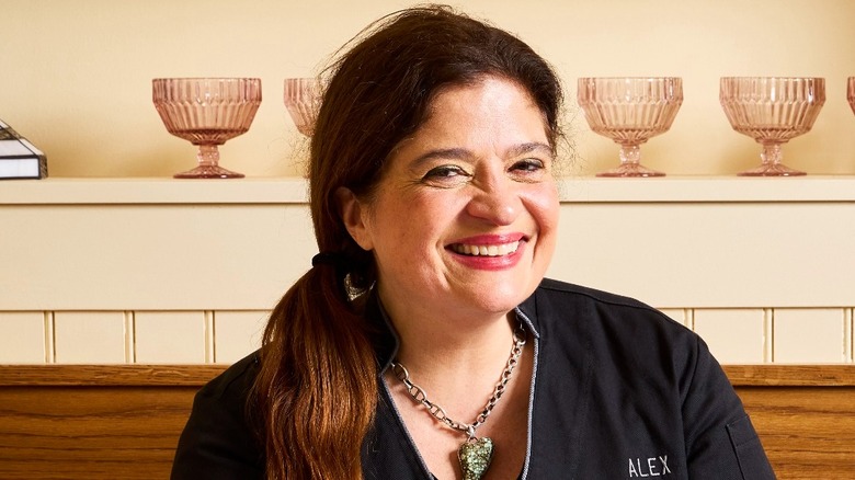 Alex Guarnaschelli with a cake on a cake stand