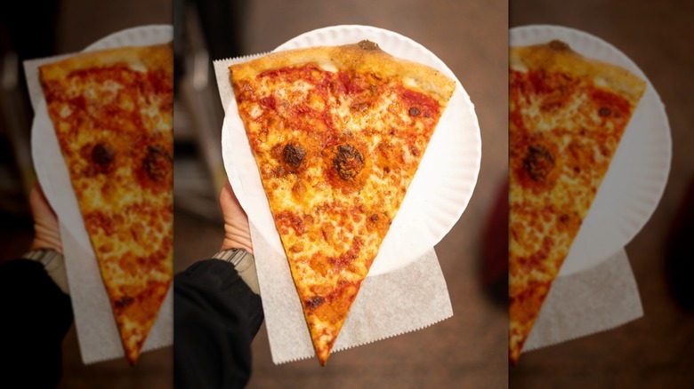 Slice of plain cheese pizza on a paper plate