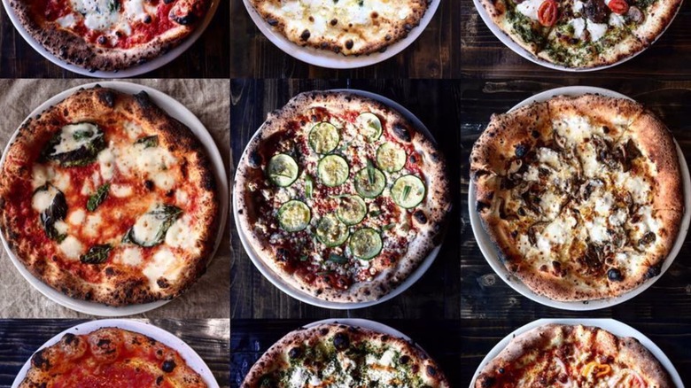 Assortment of pizzas on a wooden background