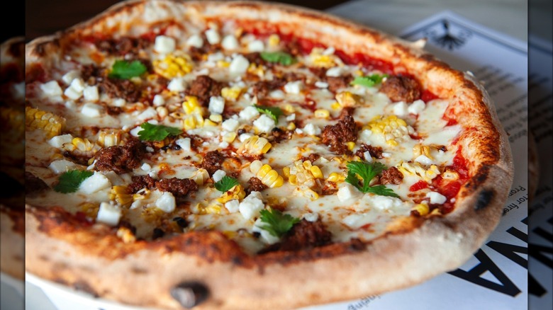 Wood-fired pizza with sweet corn, cilantro, chorizo, and cheese