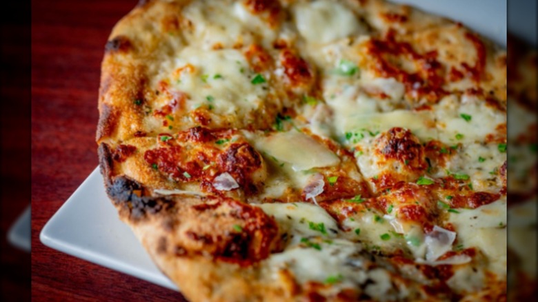 Close-up of wood-fired pizza with cheese