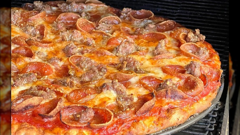Columbus-style pizza with pepperoni on oven rack