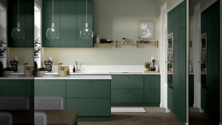 Minimalistic kitchen with sage green cabinetry from Ikea.