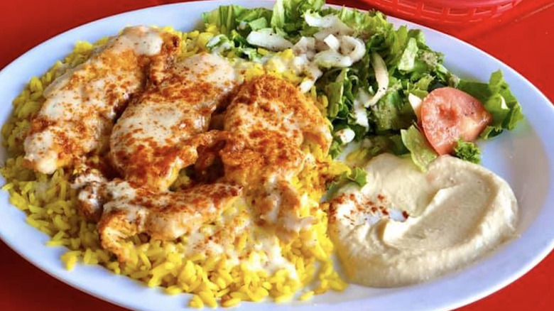 Protein plate with golden rice, hummus, and salad at Falafel King in Pike Place Market