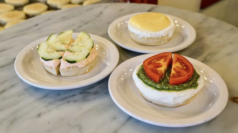 Three crumpets at Pike Place Market on white plates with fresh toppings