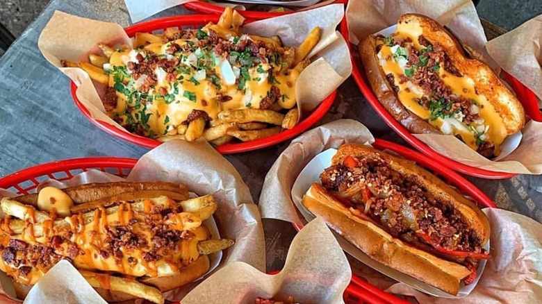 Hot dogs and loaded fries in baskets on table
