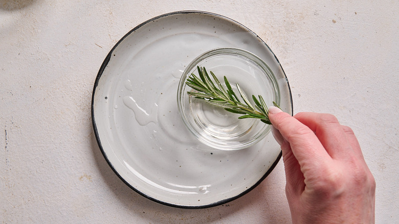 coating rosemary sprig in simple syrup