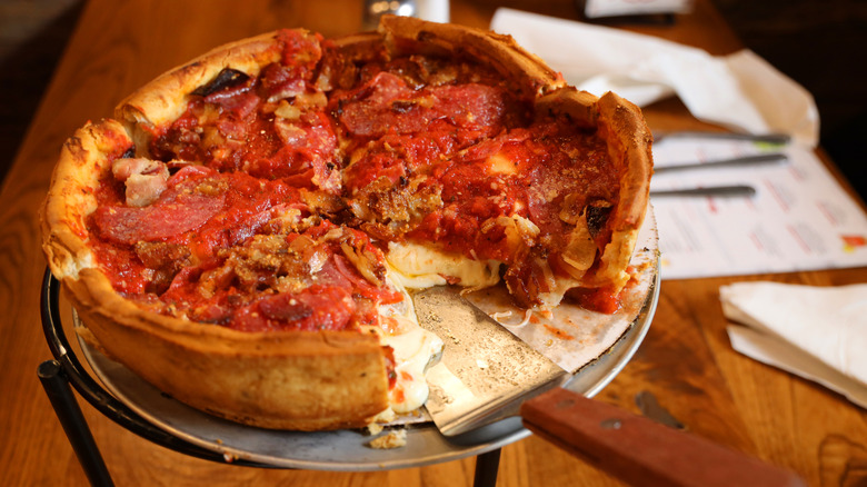 Chicago style deep-dish pizza on stand