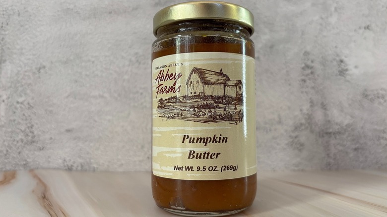 Jar of Abbey Farms pumpkin butter on grey background