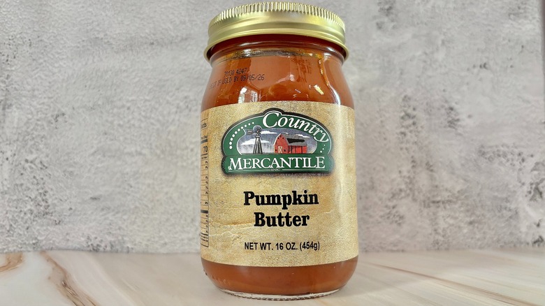 Jar of Country Mercantile pumpkin butter on grey background
