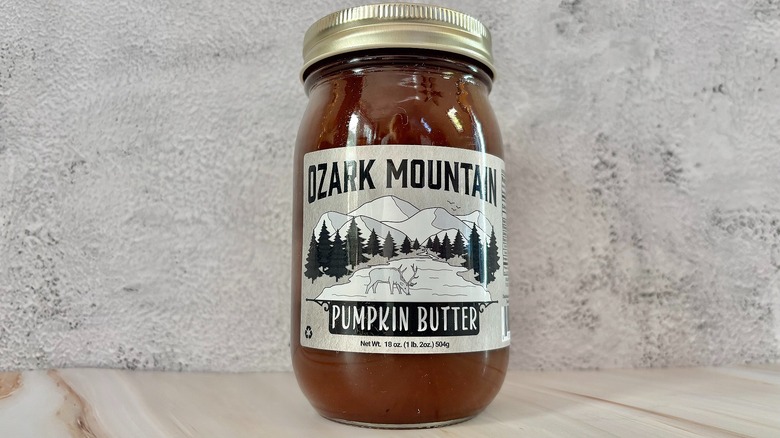 Jar of Ozark Mountain pumpkin butter on grey background