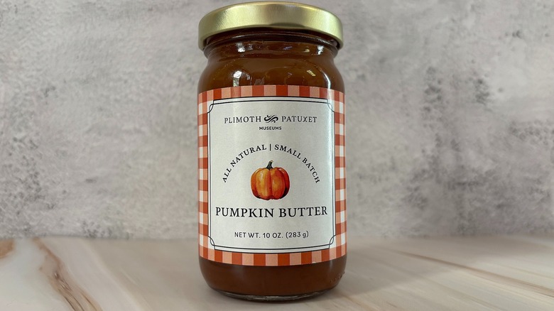 Jar of Plimoth Patuxet pumpkin butter on grey background