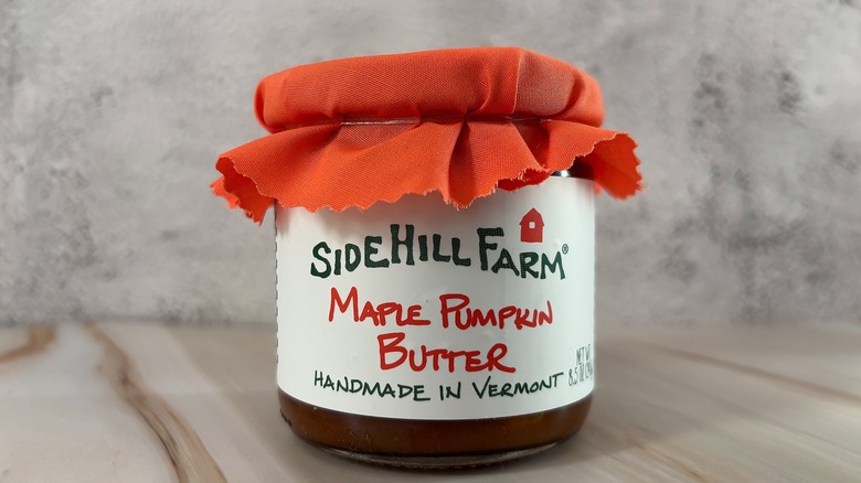 Jar of Sidehill Farm pumpkin butter on grey background