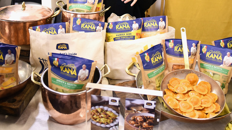 Bags of Rana pasta in pots and pans on display