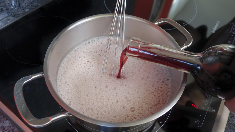 adding wine to a sauce