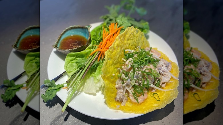 Vietnamese crepe, carrots, and greens on white plate served at Star Noodle
