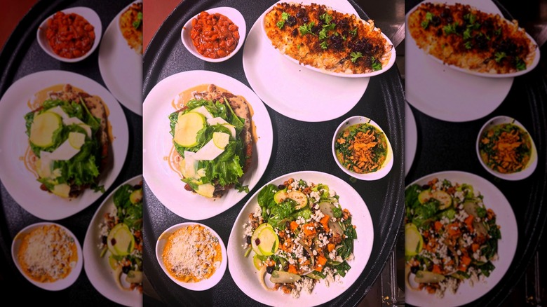 Top-down shot of several dishes from The Tuckaway Tavern & Butchery on white plates