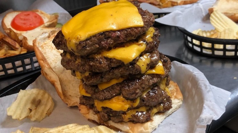 Close-up of burger with 6 patties and cheese slices