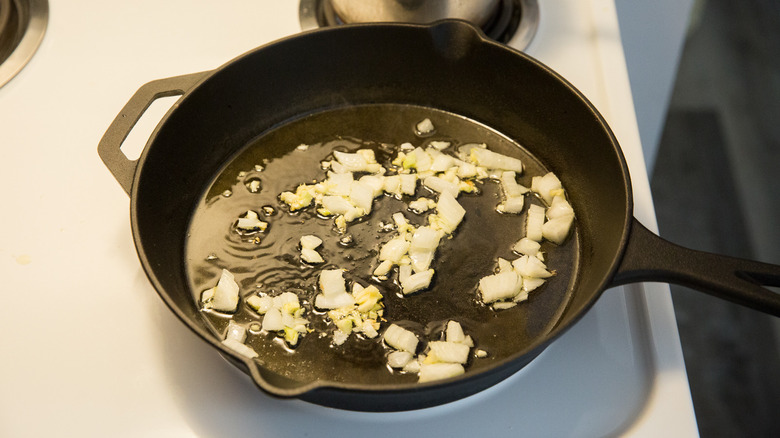 onion sauteing in iron pan