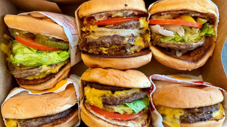 Several In-N-Out hamburgers in a red tray