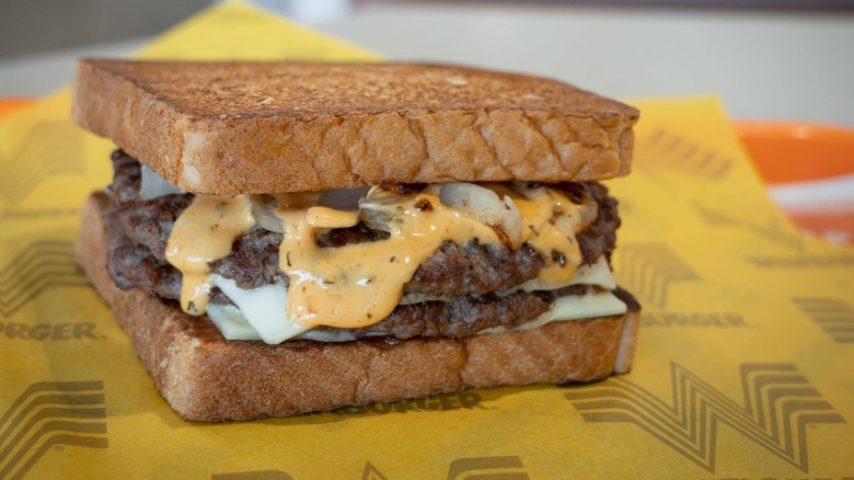 A Whataburger Patty Melt atop branded wrapping paper