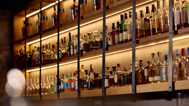 Liquor bottles on a bar shelf.