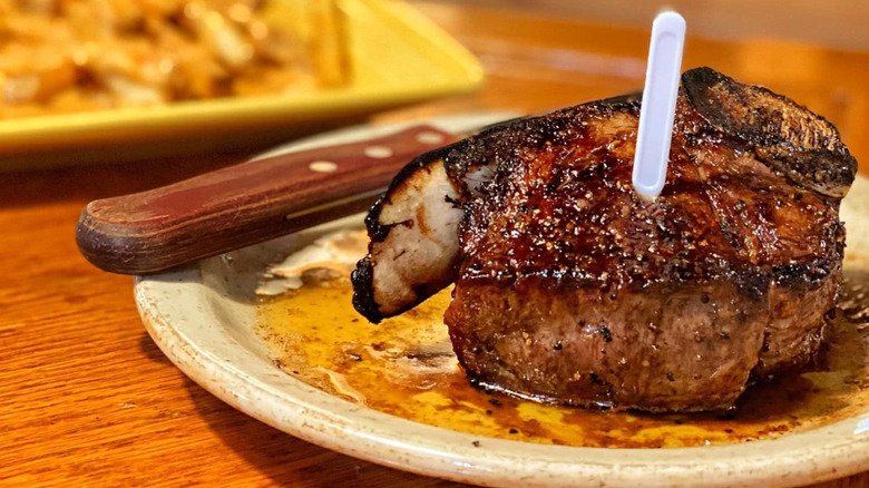 Plated juicy steak and knife