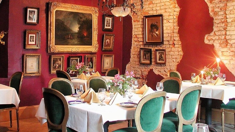 Elegant restaurant interior with set tables and red brick wall