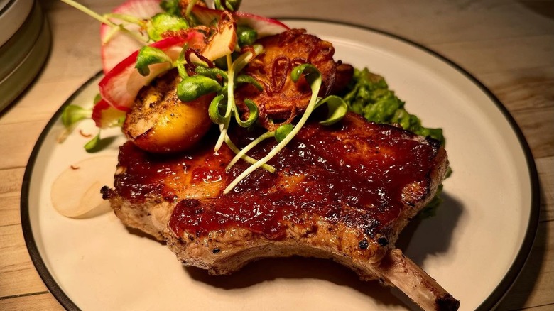 Plated pork chops with greens
