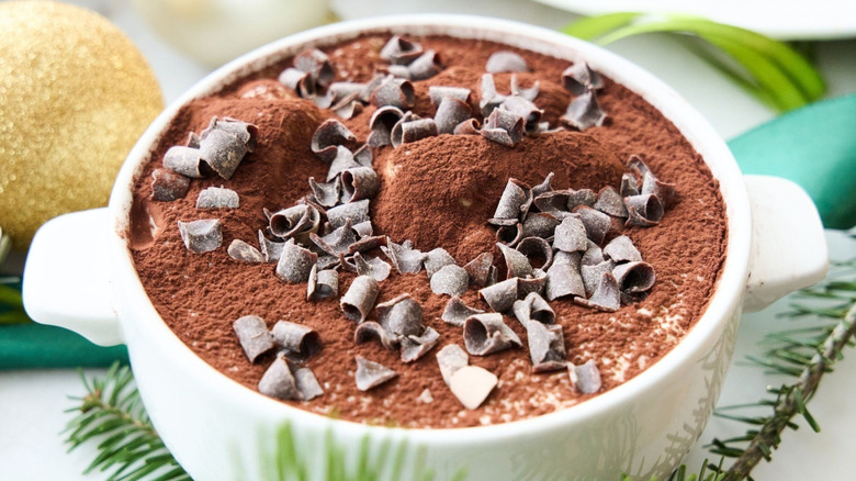 Tiramisu sprinkled with shaved chocolate in white ramekin