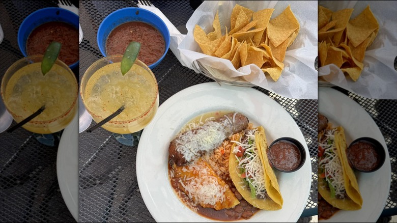 Top view of mango margarita, chips, salsa, and taco plate