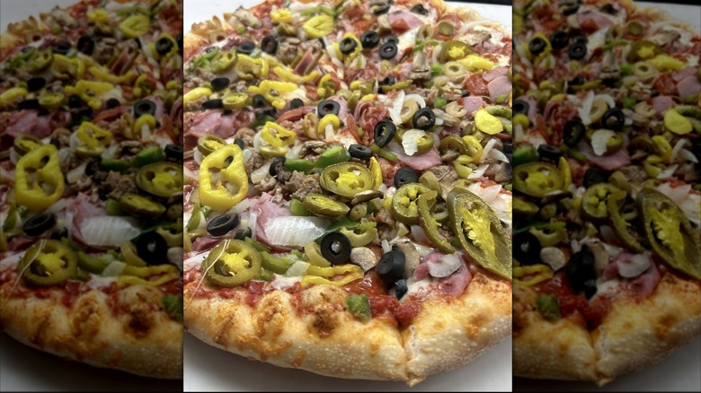 Artisan pizza smothered in jalapeños, black olives, and onions