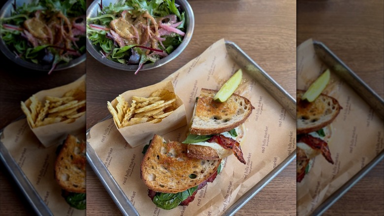 Top view of breakfast sandwich, chips, and salad